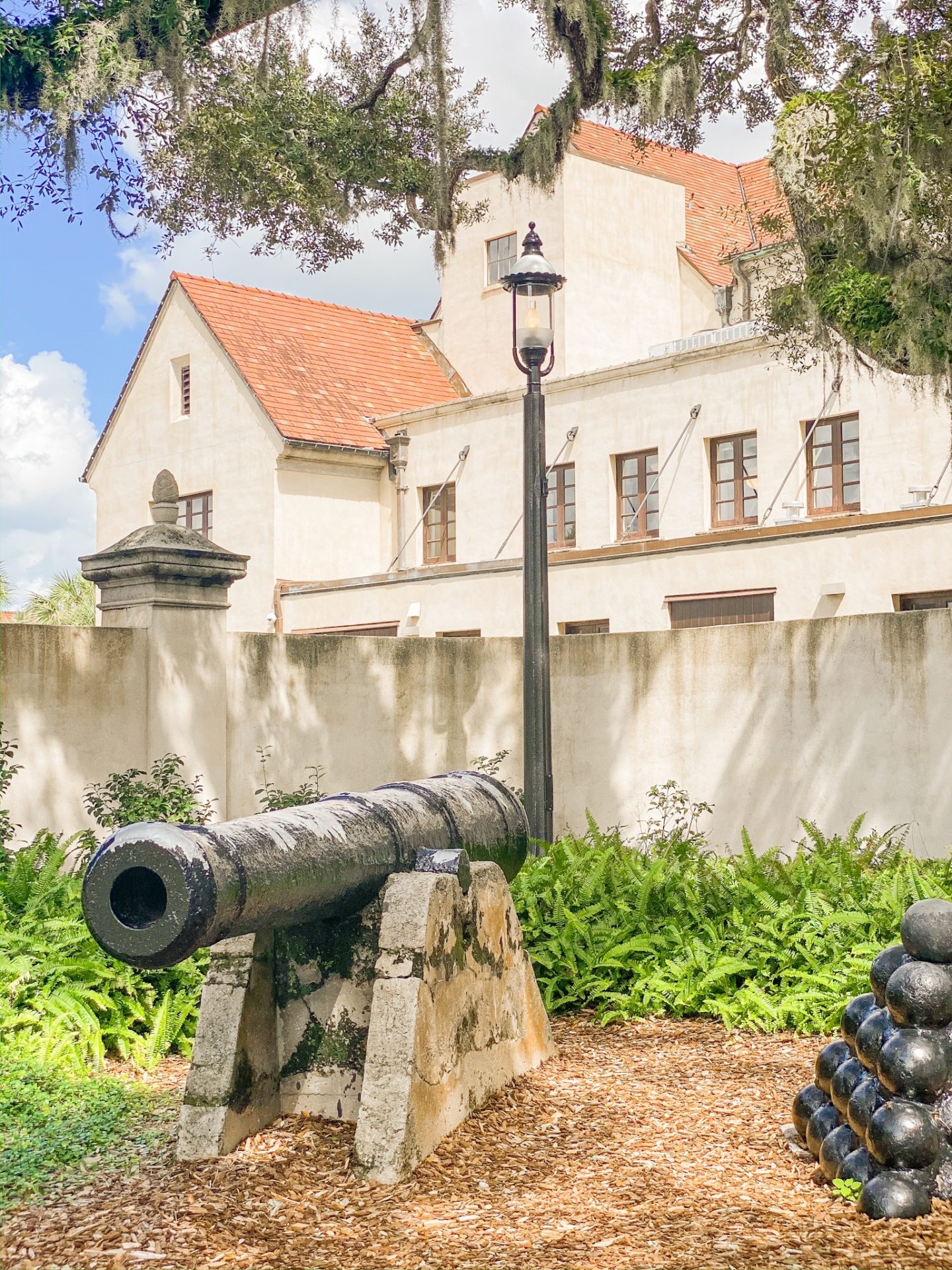 governors house in st augustine florida with a canon and canon balls outside of it